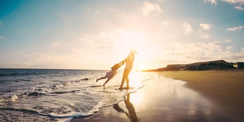 Mother and daughter having fun on tropical beach
